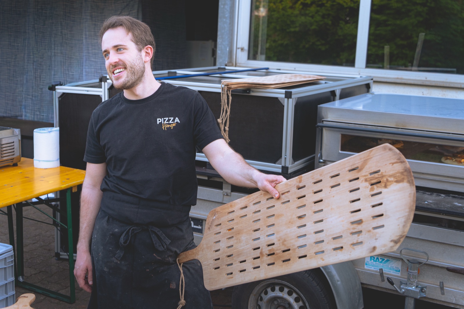 Pizzabäcker am Ofen des Pizza-Anhängers